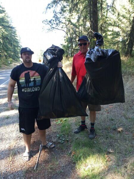 Two Men Picking Up Trash - Community Service